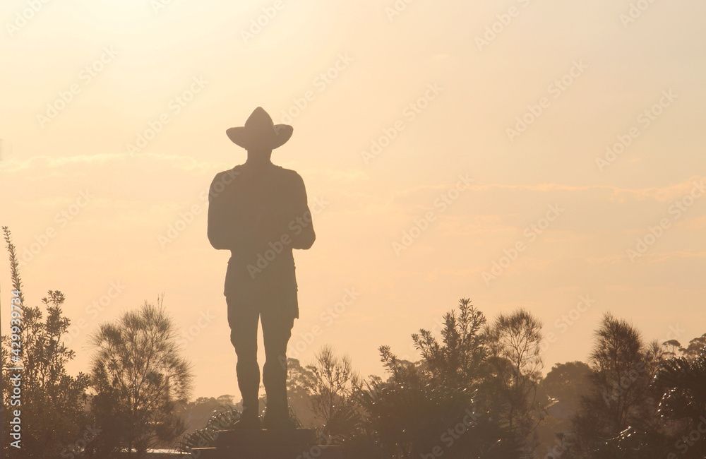 A silhouette of an Anzac monument in the afternoon light